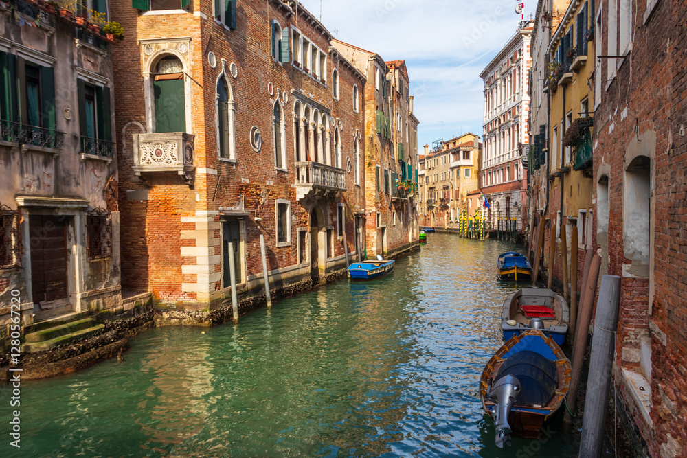 Fototapeta premium Traditional narrow romantic canal with old houses in Venice, Italy