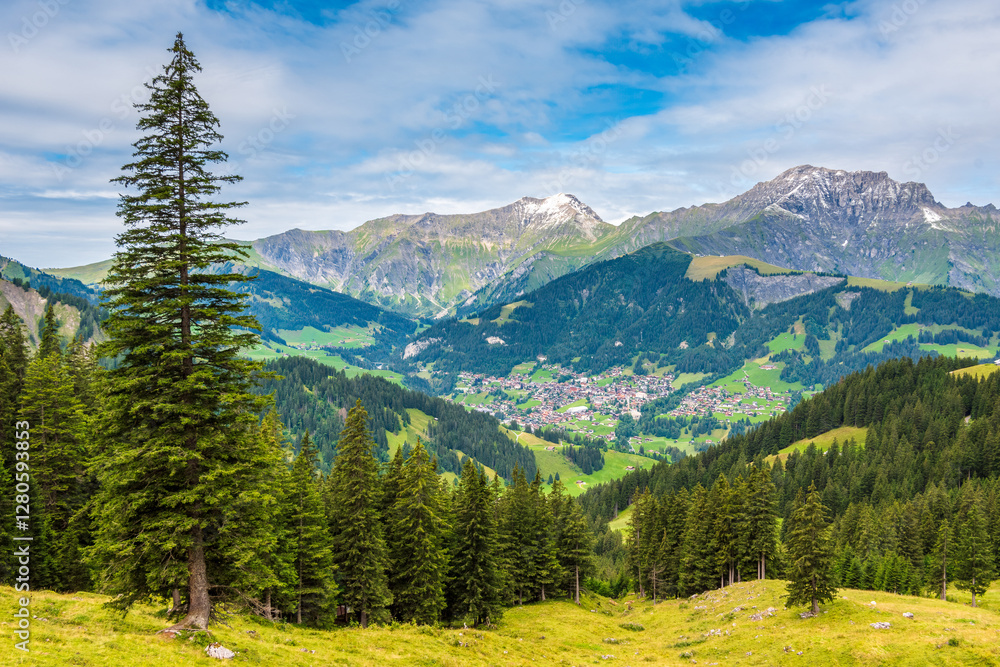Obraz premium Scenic view of Adelboden, a beautiful mountain village and municipality in Switzerland, located in the administrative district of Frutigen in the Bernese Mountains.