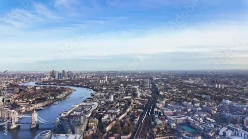 Wallpaper Mural Timelapse of Tower Bridge and Canary Wharf skyline, showing London's modern and historic architecture with trains rushing along tracks and ferries in water Torontodigital.ca