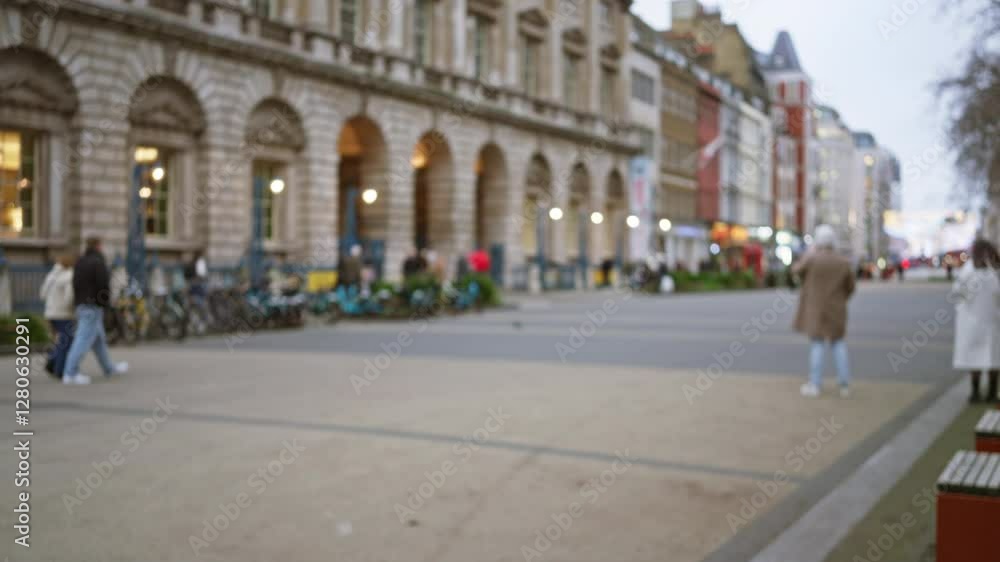 Blurry winter street scene in london with defocused pedestrians and historic architecture creating a bokeh background. Blurry winter street scene in london with defocused pedestrians and historic architecture creating a bokeh background.