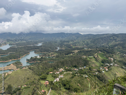 Scenic view of lush green hills, winding rivers, and cloudy sky creating a tranquil landscape.