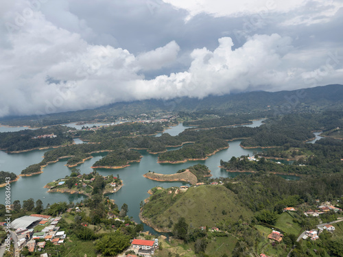 Lush green landscape with interconnected waterways under a cloudy sky.