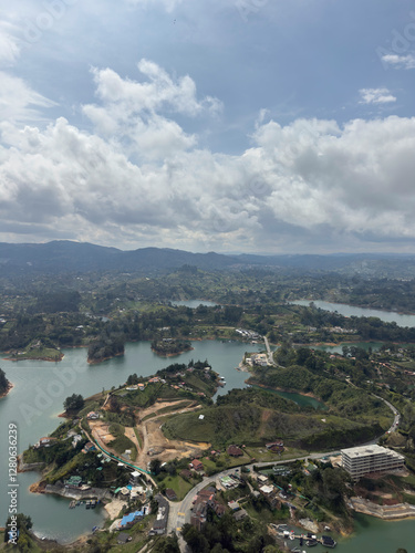Aerial view of winding river and lush landscape under a cloudy sky.