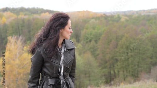 Central park in New York. Girl in fall trench. Autumn landscape with gothic woman has windy hair. Stylish woman sing in autumn landscape outdoor. Fall nature landscape and girl. Thoughtful girl