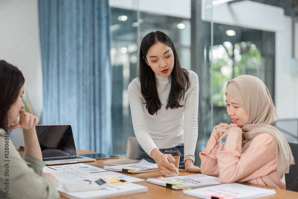 Female team members brainstorming ideas in a collaborative office environment. Female team members brainstorming ideas in a collaborative office environment.