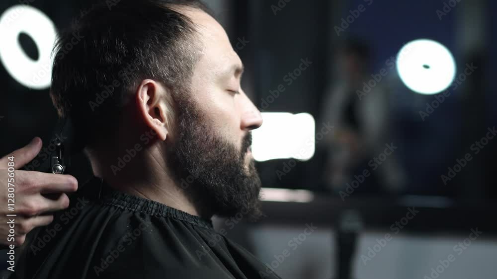 Professional barber wielding electric hair clipper, meticulously grooming bearded client's hair in contemporary barbershop, delivering precision men's hairstyling Professional barber wielding electric hair clipper, meticulously grooming bearded client's hair in contemporary barbershop, delivering precision men's hairstyling
