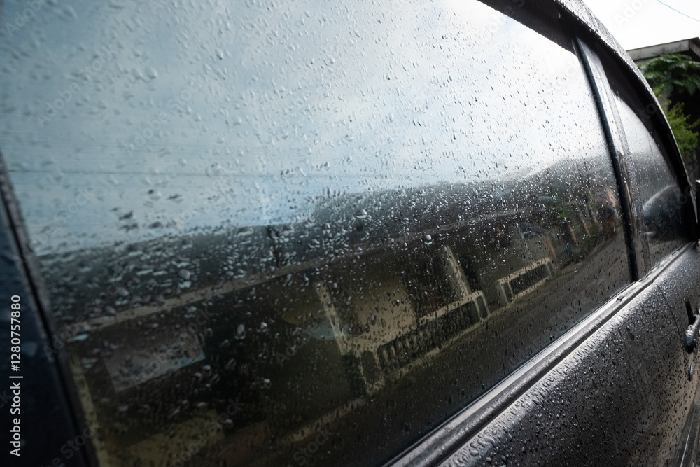A car window covered in mist, with condensation forming a foggy pattern, set in an outdoor environment A car window covered in mist, with condensation forming a foggy pattern, set in an outdoor environment
