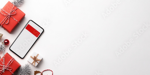 Holiday shopping essentials with gifts and smartphone flat lay for christmas design