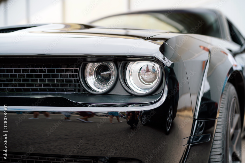 Fototapeta premium Close-Up of a Black Vintage Car Headlight and Front Design