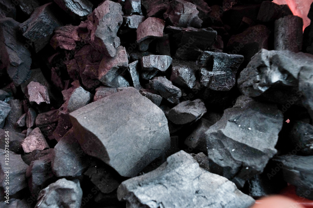 Charcoal made from wood, showing dark, rough, and irregular pieces, ready for use in cooking or heating Charcoal made from wood, showing dark, rough, and irregular pieces, ready for use in cooking or heating