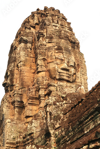 The top of one of the towers of the Bayon Temple, a big face, head is carved in the sandstone bricks, Angkor Wat, Siem Reap, Cambodia photo