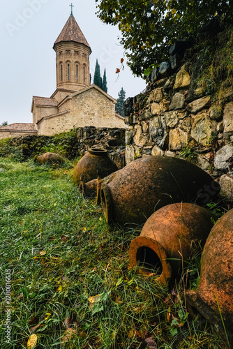 View on the Ikalto church, part of the Monastery and academy complex from the 6th century with qveri, clay vessels used to make wine in Kakheti (Georgia) photo