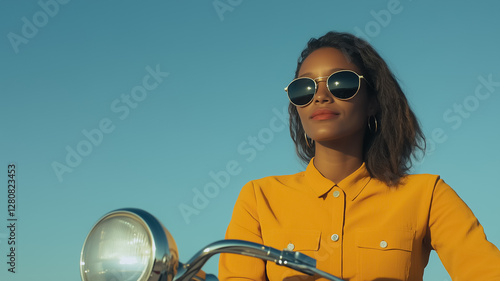 Woman on Scooter: Confident woman with sunglasses is riding a scooter, soaking in the sunshine and embracing freedom under clear blue sky.  photo