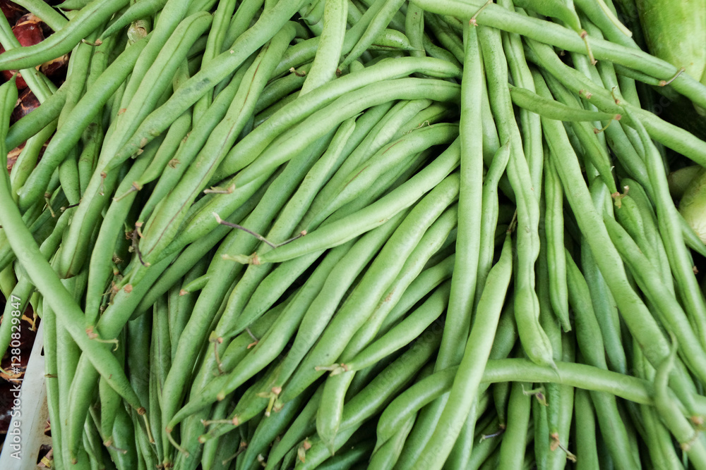 Fresh green beans (buncis) with a smooth surface and firm texture, showcasing their natural freshness and crisp quality. Commonly used in various dishes Fresh green beans (buncis) with a smooth surface and firm texture, showcasing their natural freshness and crisp quality. Commonly used in various dishes