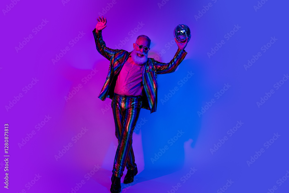Fototapeta premium Full size photo of macho senior male hold disco ball dressed colorful sequins striped garment isolated on blue purple neon light background