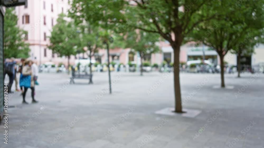 Blurred scene of women walking and talking in la spezia street with trees and benches in background, showcasing a peaceful european town atmosphere. Blurred scene of women walking and talking in la spezia street with trees and benches in background, showcasing a peaceful european town atmosphere.
