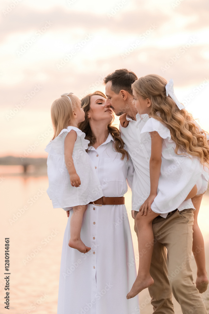 happy family with two children in white clothes walking on the river bank at sunset happy family with two children in white clothes walking on the river bank at sunset