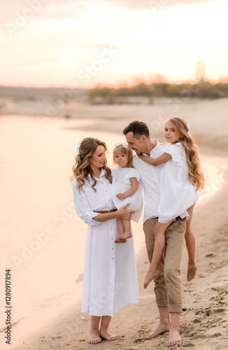 Bilde på lerret happy family with two children in white clothes walking on the river bank at sun