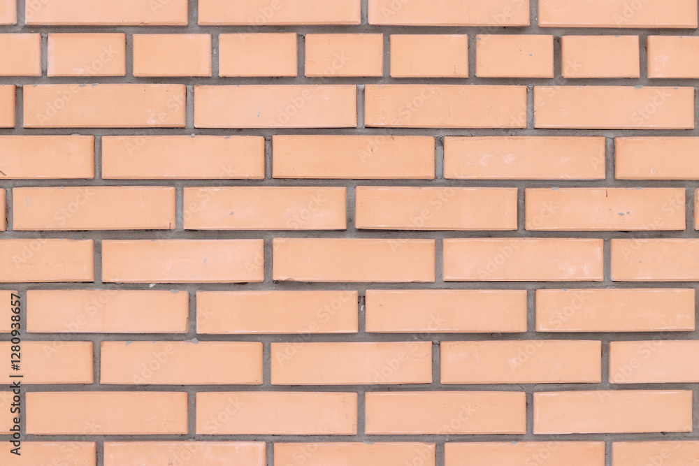 Obraz premium Orange brick wall background for exterior design. Construction concept, outdoor buildings, garage or house. Wall with classic checkerboard pattern and visible joints