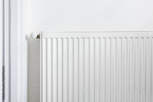 Wallpaper Mural Close-up of a white metal radiator with a temperature control valve. Modern home heating system, energy efficiency concept. Minimalistic interior with clean lines and functional design Torontodigital.ca
