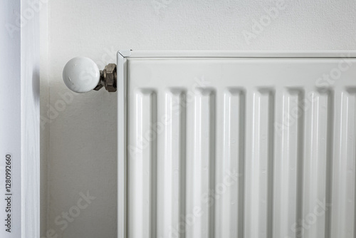 Wallpaper Mural Close-up of a white metal radiator with a temperature control valve. Modern home heating system, energy efficiency concept. Minimalistic interior with clean lines and functional design Torontodigital.ca