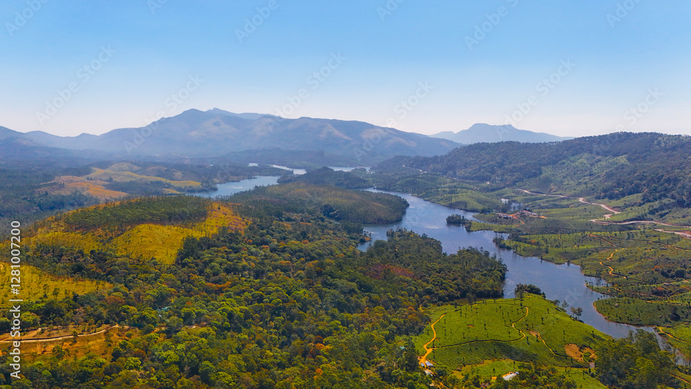Obraz premium Mesmerizing Aerial View of Suryanelli Village, Munnar’s Rolling Tea Estates