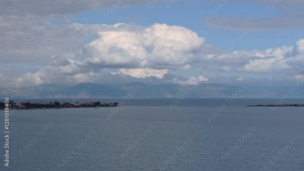 Drone shot of the sea in Artemida, Greece with mountains and clouds in the background Drone shot of the sea in Artemida, Greece with mountains and clouds in the background