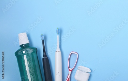 Wallpaper Mural Daily dental care essentials including toothbrushes, mouthwash, and floss on blue background Torontodigital.ca