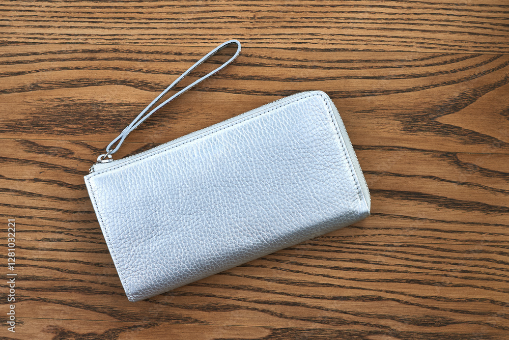 Elegant silver leather wallet on wooden surface showcasing fashion accessory style concept