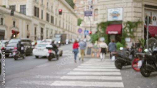 Wallpaper Mural Blurry pedestrians and vehicles on a busy street in rome, italy, showcase the dynamic urban life against a backdrop of historic architecture and vibrant city movement. Torontodigital.ca
