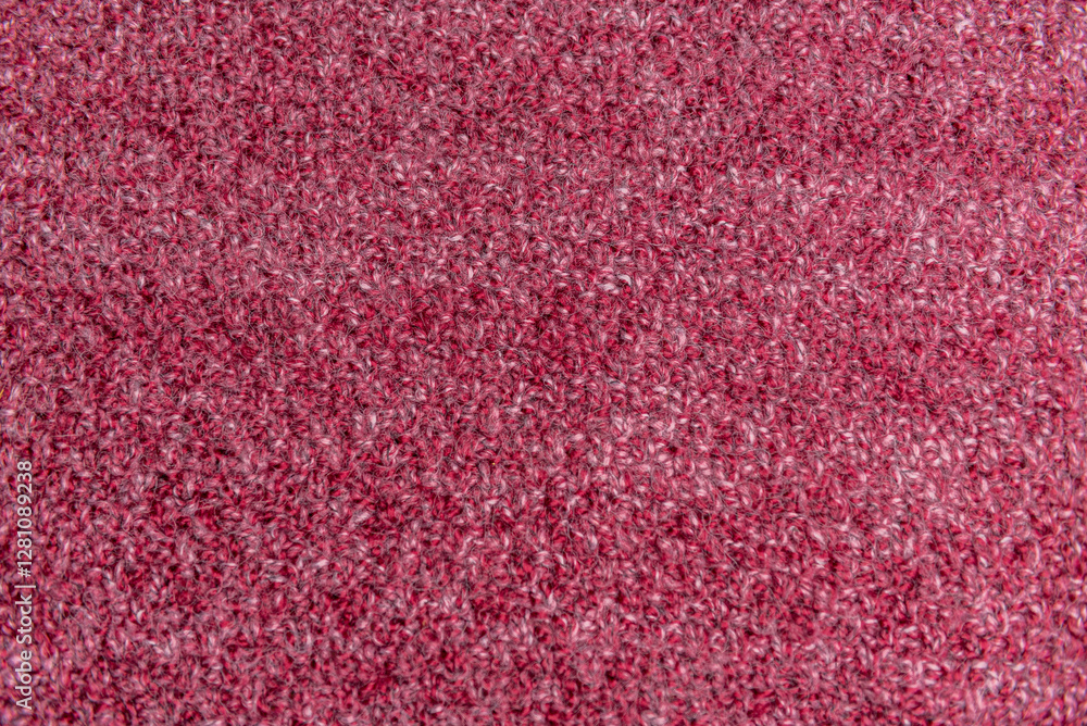 Fototapeta premium Close up of pink homemade knitted fabric with large stitches. Textured background