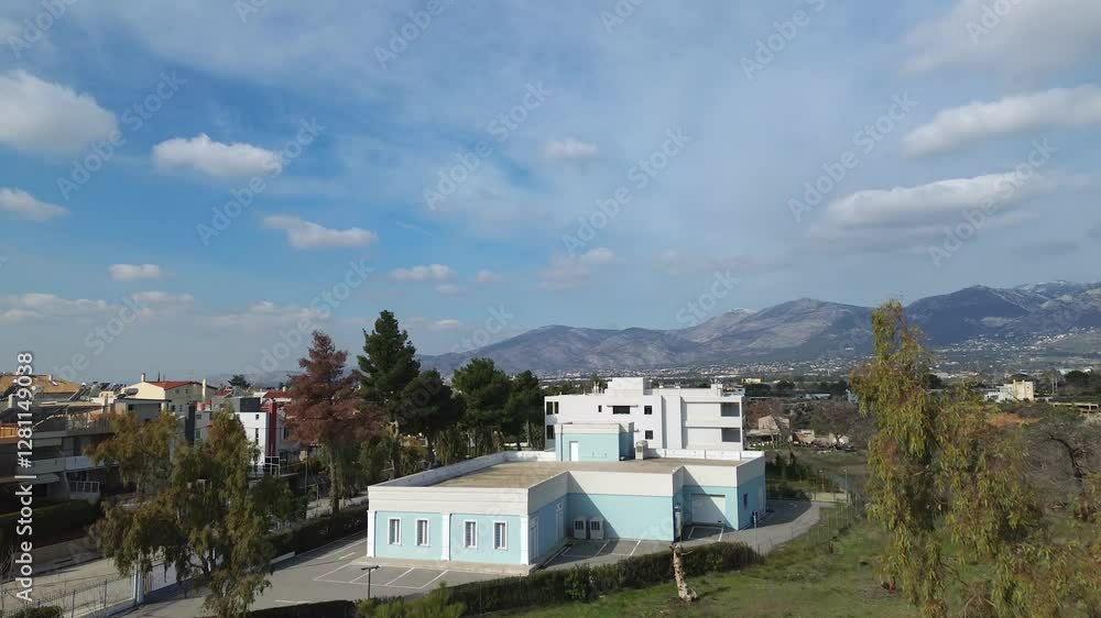 Aerial establishing push in shot, revealing Parnitha mountain over tall trees, blue sky with white clouds formations 4K Aerial establishing push in shot, revealing Parnitha mountain over tall trees, blue sky with white clouds formations 4K