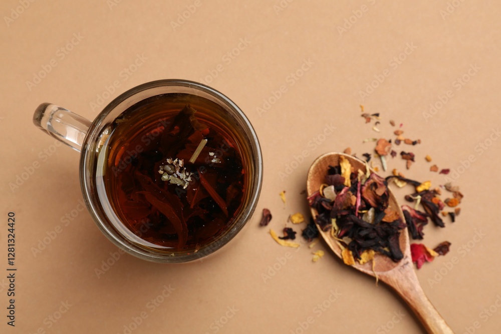 Fototapeta premium Aromatic tea and dried leaves on brown background, flat lay