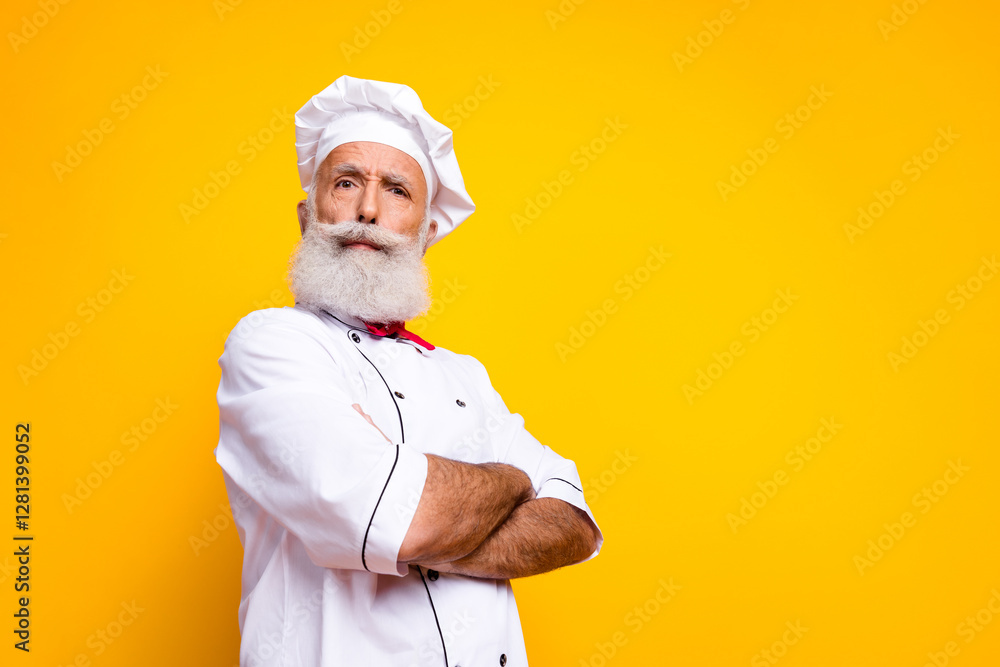 Confident senior chef with a white beard and chef hat against a vibrant yellow background Confident senior chef with a white beard and chef hat against a vibrant yellow background