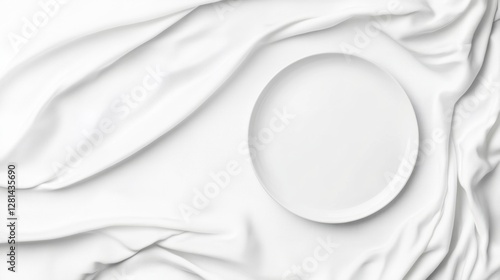 A white plate rests on a rumpled white tablecloth, creating a minimalist and serene composition