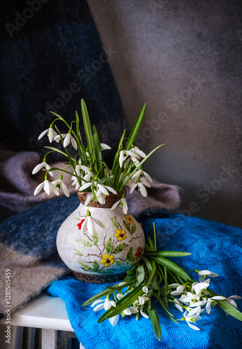 Obraz na płótnie An Elegant Floral Arrangement Placed in a Ceramic Pitcher Surrounded by Beautiful Textiles w salonie
