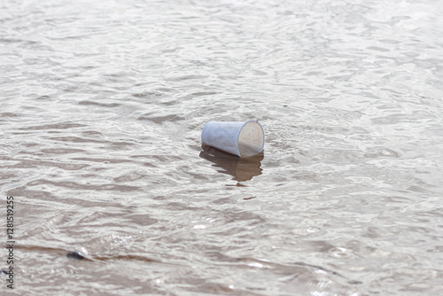 A plastic cup floating in the sea.