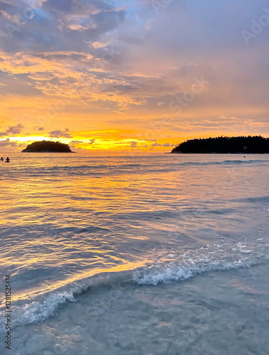 sunset over the sea with colorful orange sky and  silhouette of small islands.