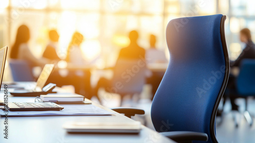 Wallpaper Mural modern office setting featuring blue ergonomic chair, with blurred background of business team meeting. warm sunlight creates productive atmosphere Torontodigital.ca