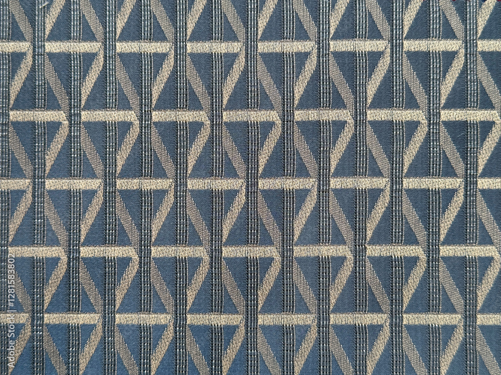 Close up of dark blue color fabric in random geometric diamond and lines pattern. Dark blue and silver grey color fabric in abstract modern geometrical texture. Seamless fabric background texture.