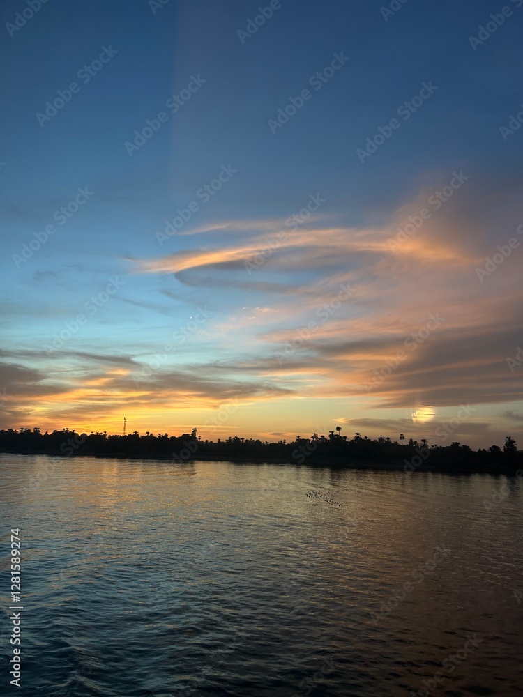 Naklejka premium sunset over the river