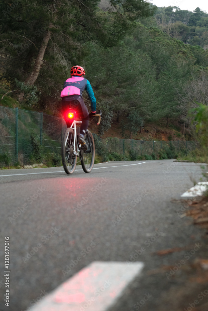Cyclist on the roadway outside the city Cyclist on the roadway outside the city