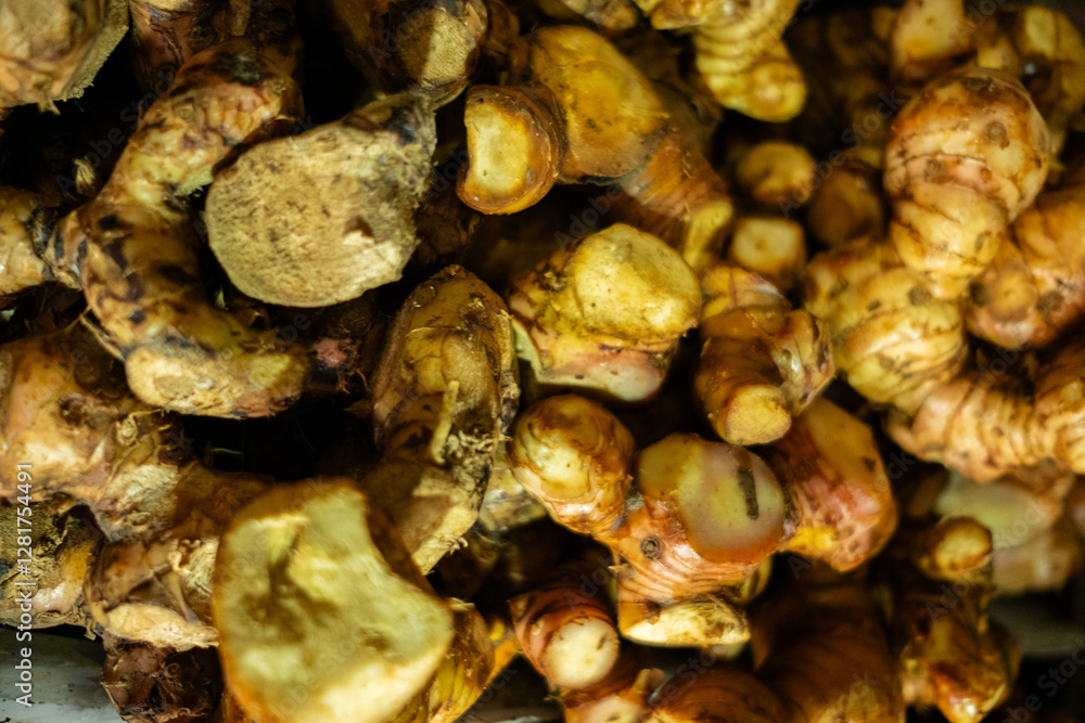 Fresh raw galangal roots displayed with their firm texture and reddish-brown skin, widely used in Asian cuisine and traditional herbal medicine Fresh raw galangal roots displayed with their firm texture and reddish-brown skin, widely used in Asian cuisine and traditional herbal medicine