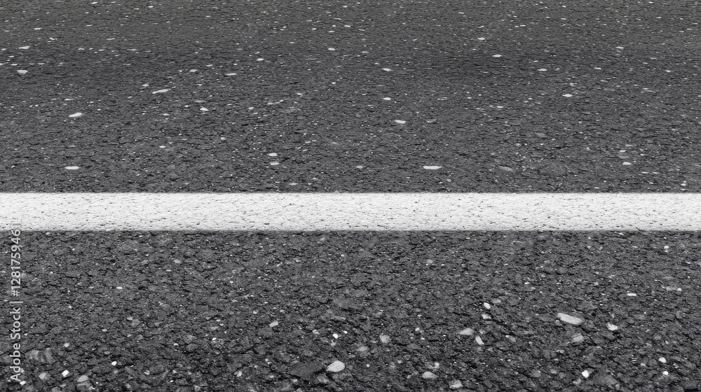 Fototapeta premium Close-up of asphalt road with white line as urban infrastructure concept