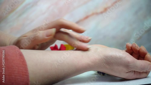 Wallpaper Mural A woman applying amber liquid homemade perfume from a transparent pipette bottle, with fresh flowers on a white and pink marble background. Natural and luxurious beauty concept. Torontodigital.ca