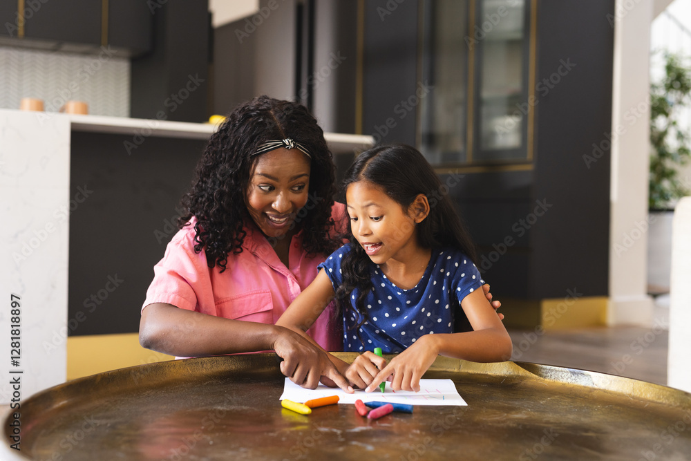 Fototapeta premium Diverse mother and daughter drawing at home, sharing creative moments and smiles