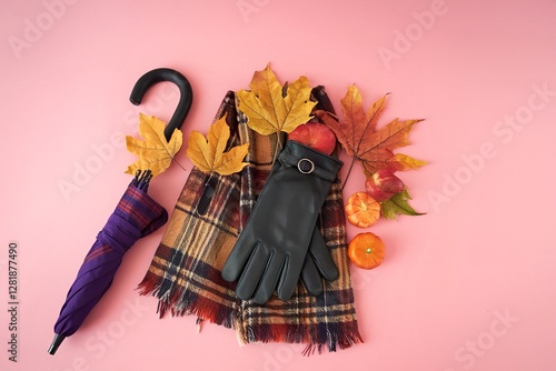 Autumn accessories umbrella, gloves and tippet on pink background