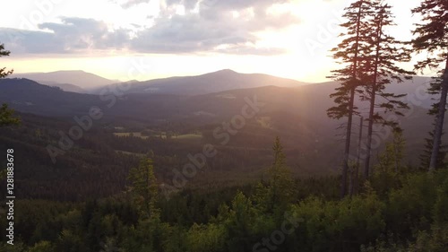 Aerial view of the sunset setting behind a mountain, illuminating the last remnants of the landscape. Beskydy Mountains, Czech Republic.