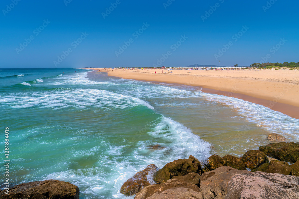 Tavira Island sandy beach the Algarve Portugal with beautiful blue sea and waves Tavira Island sandy beach the Algarve Portugal with beautiful blue sea and waves