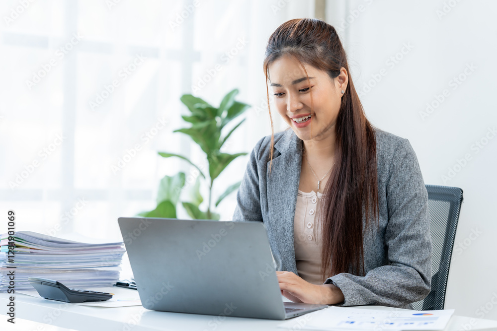 Successful Office Work: A cheerful businesswoman is fully immersed in her tasks, working diligently on her laptop. This photo perfectly encapsulates productivity, determination. Successful Office Work: A cheerful businesswoman is fully immersed in her tasks, working diligently on her laptop. This photo perfectly encapsulates productivity, determination.